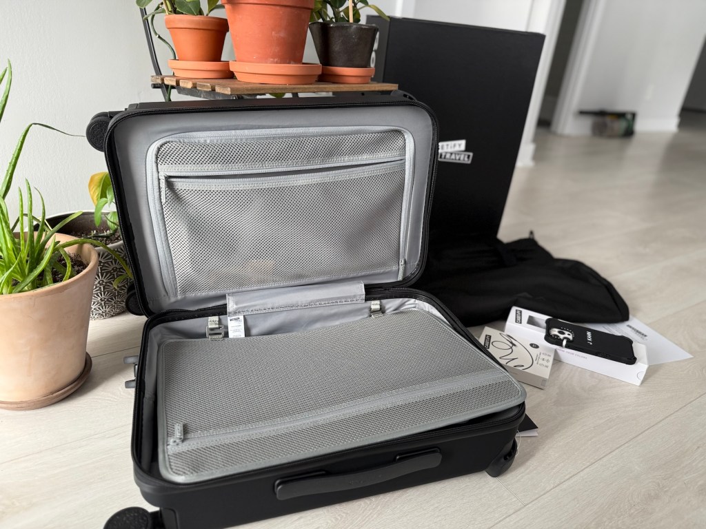 A suitcase with a few plants in it