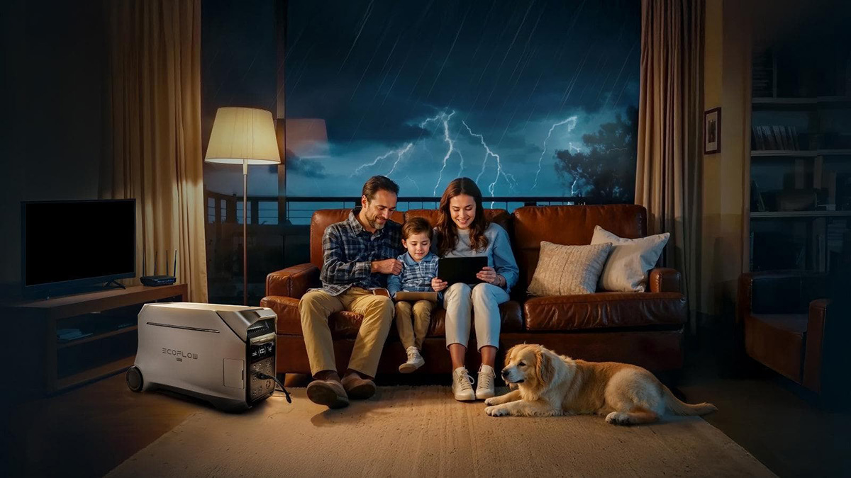 A family sitting on a couch looking at a tablet