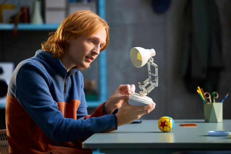 A man holding a small lamp