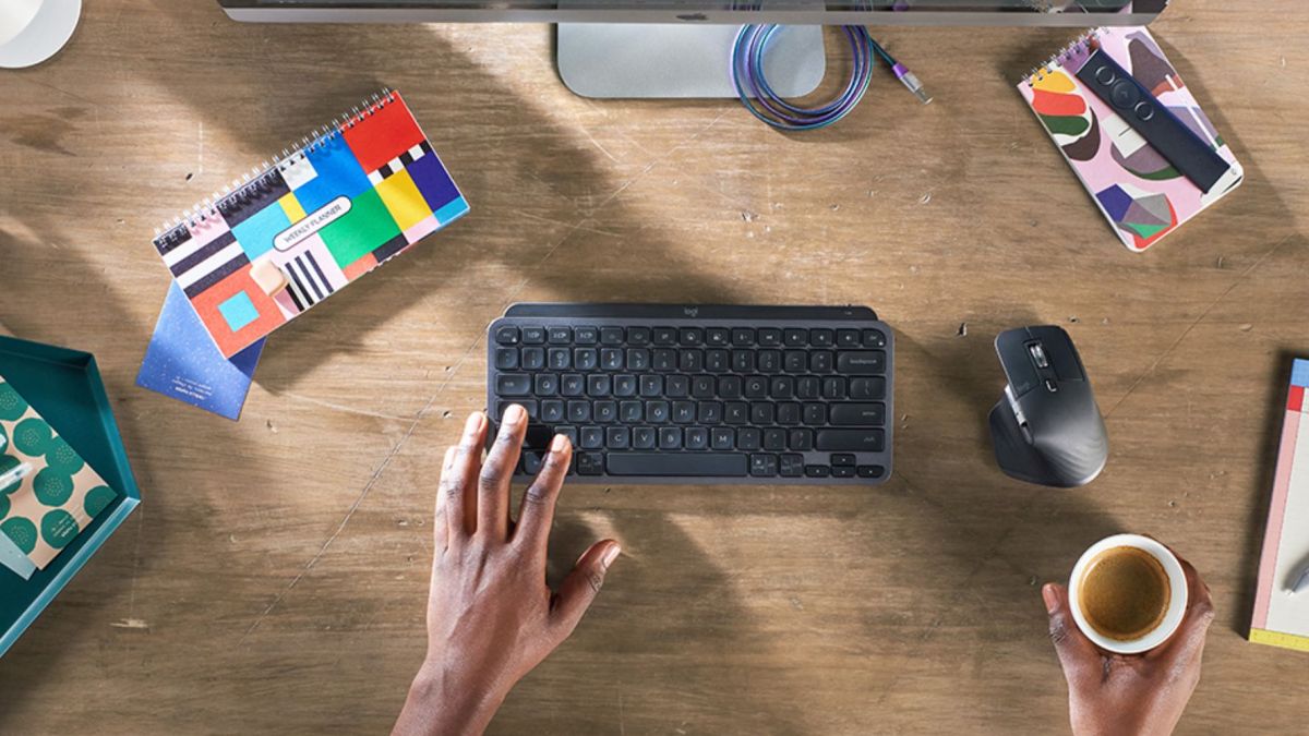 Image showing a person using Logitech's MX Keys Mini keyboard.